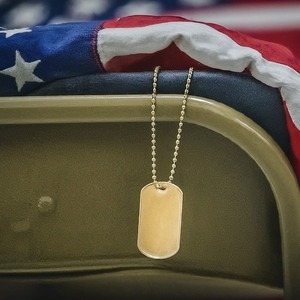 Image of a flag and dog tags on the back of a chair
