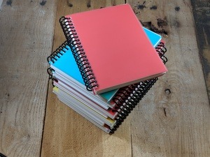Picture of a coil bound book on a wooden table